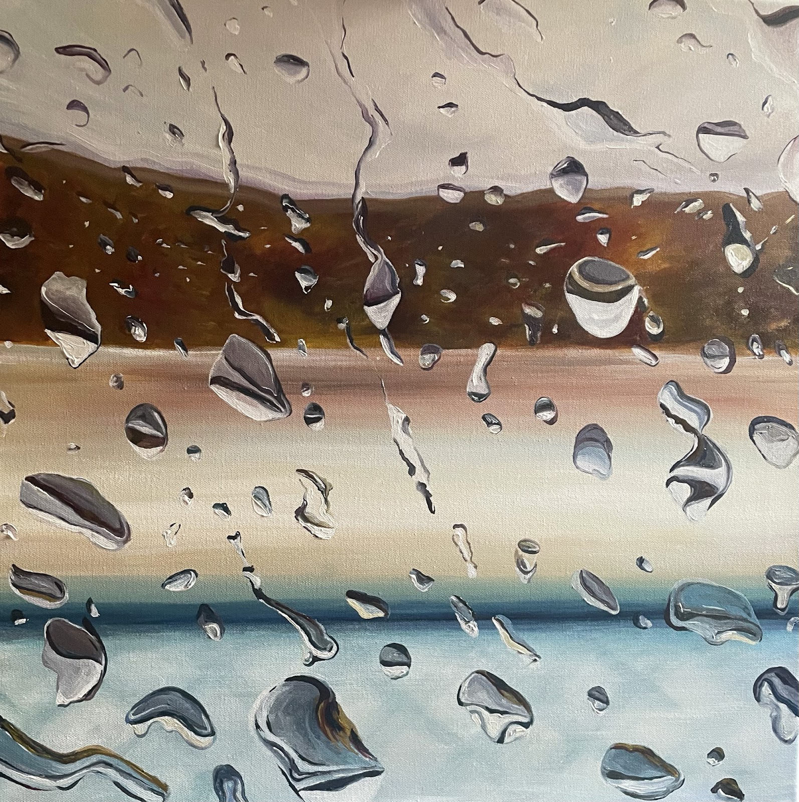 Water droplets on a background of tan, brown and blue bands of color