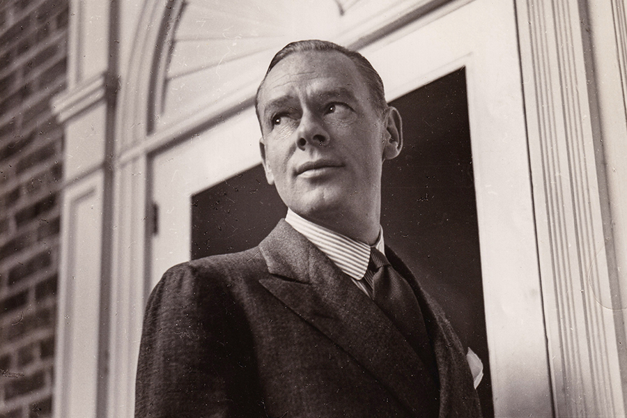 Frank Carrington standing in front of a white door of a brick building