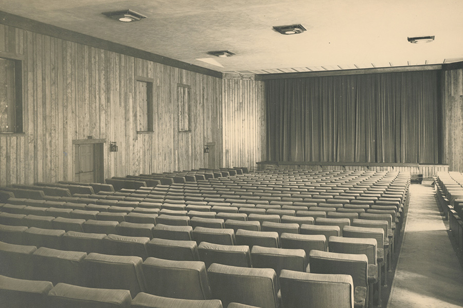 Original theater configuration. Three sections of seats on the left, center and right facing a curtained stage.